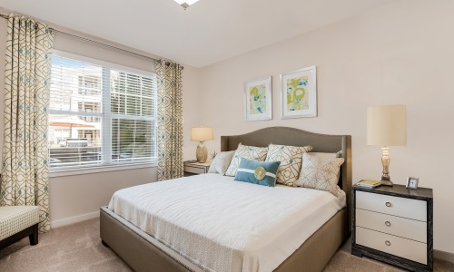 bedroom with large bed window and lamps