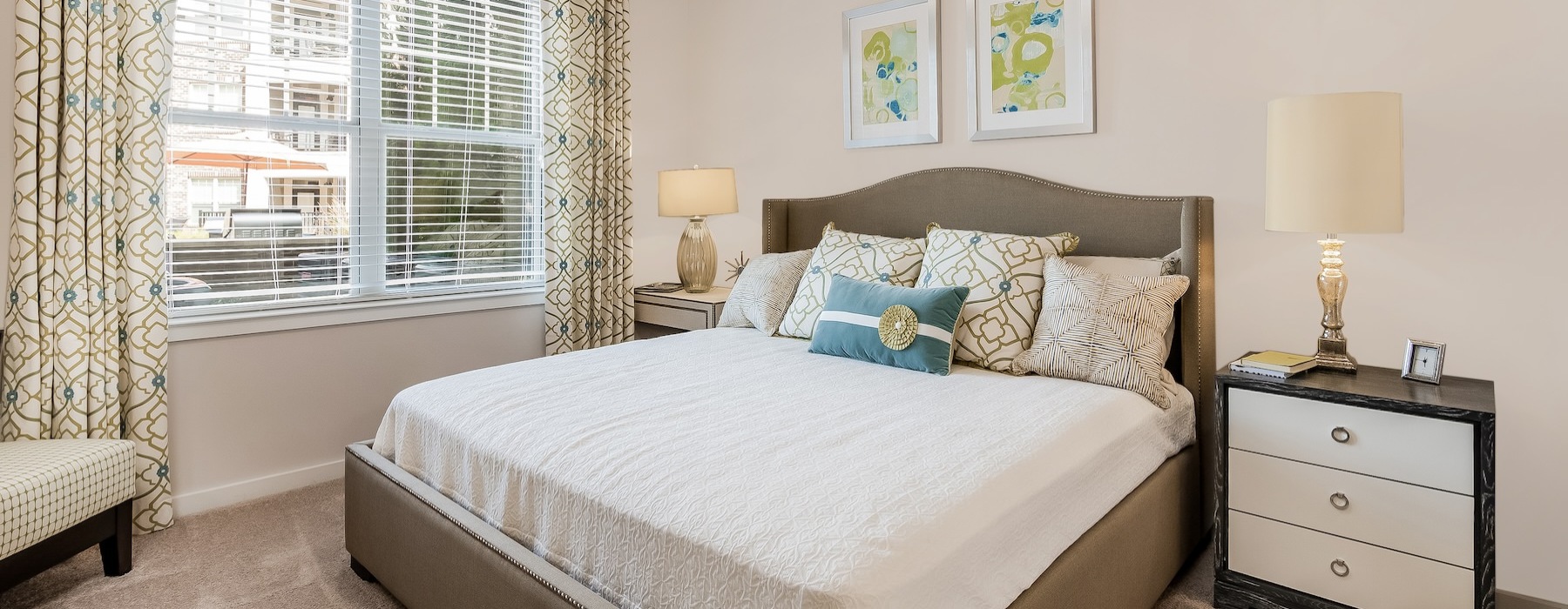 bedroom with large bed window and lamps
