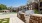 a brick wall with a brick wall and a brick wall with a pool and a brick building and