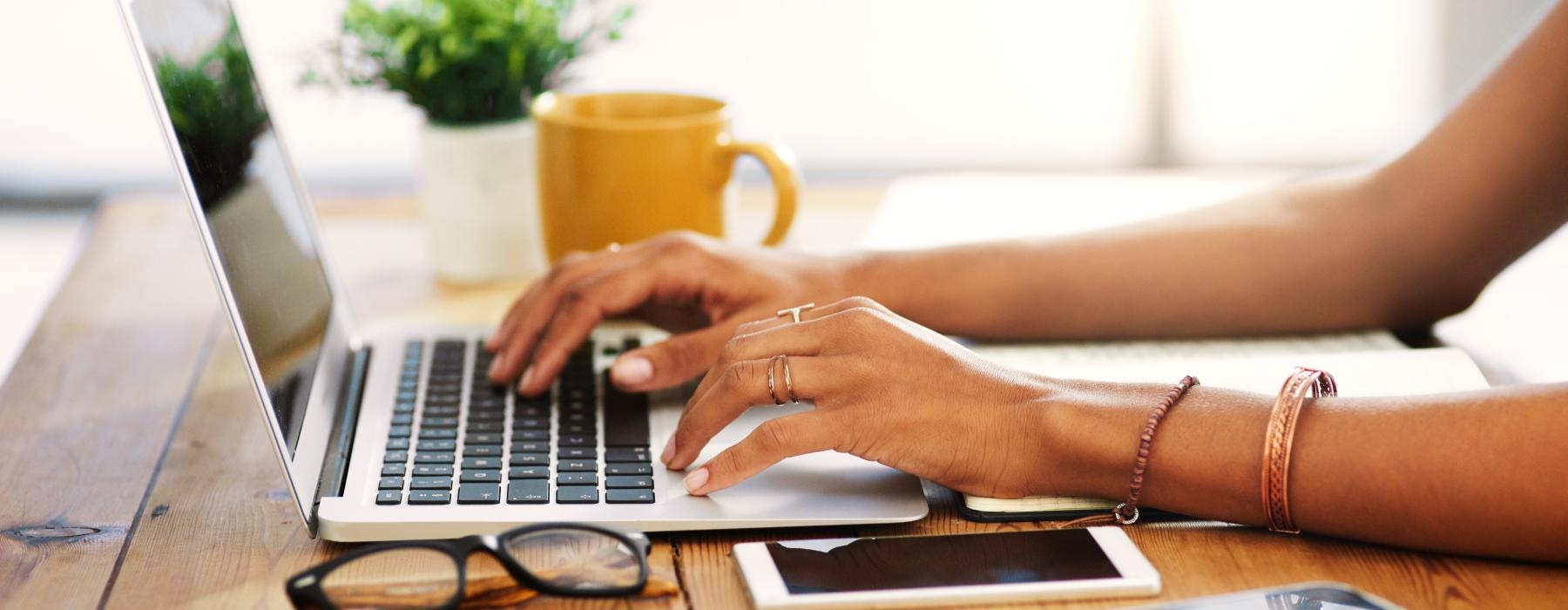 a person typing on a laptop